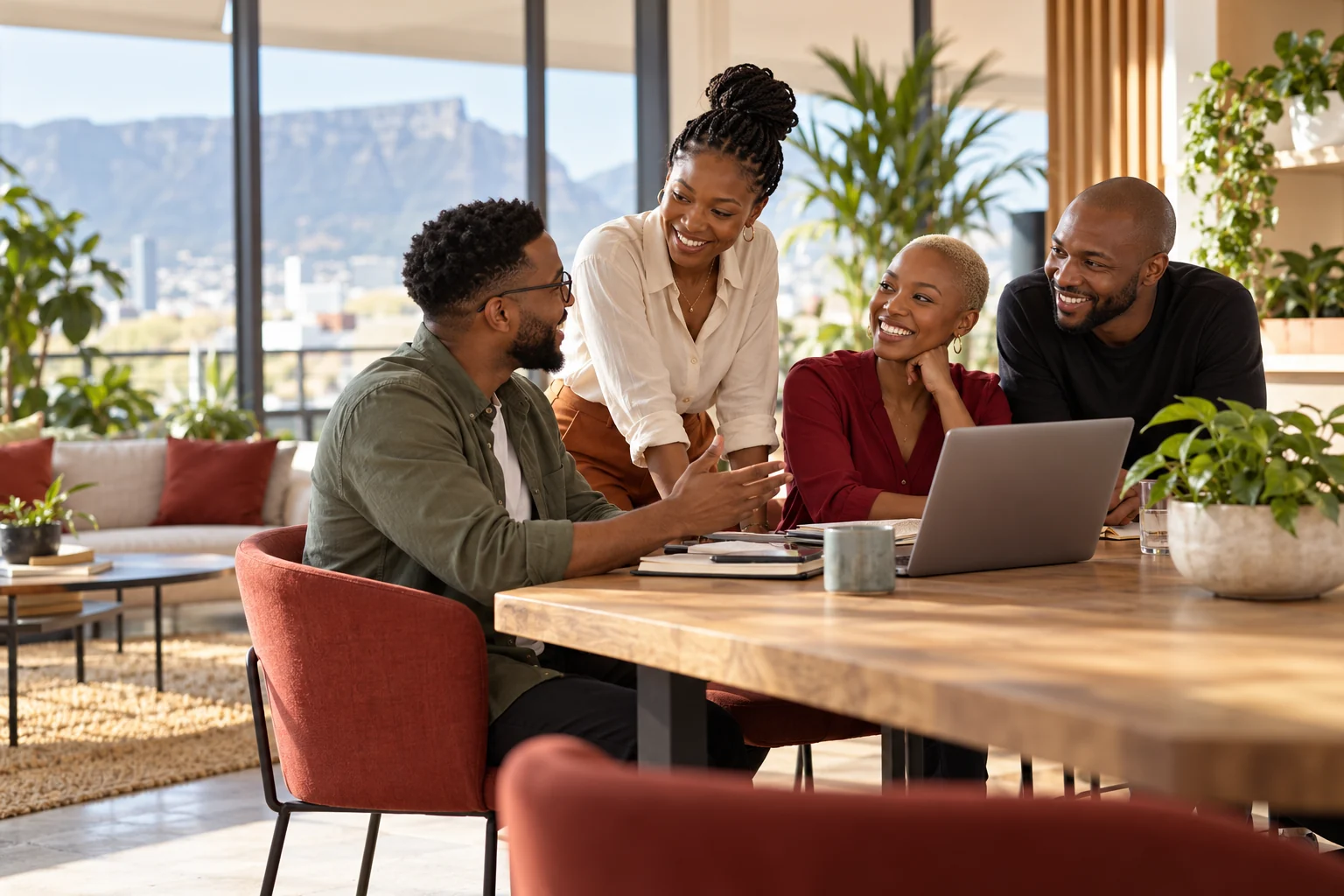 South African colleagues sharing ideas around a table in a bright workplace